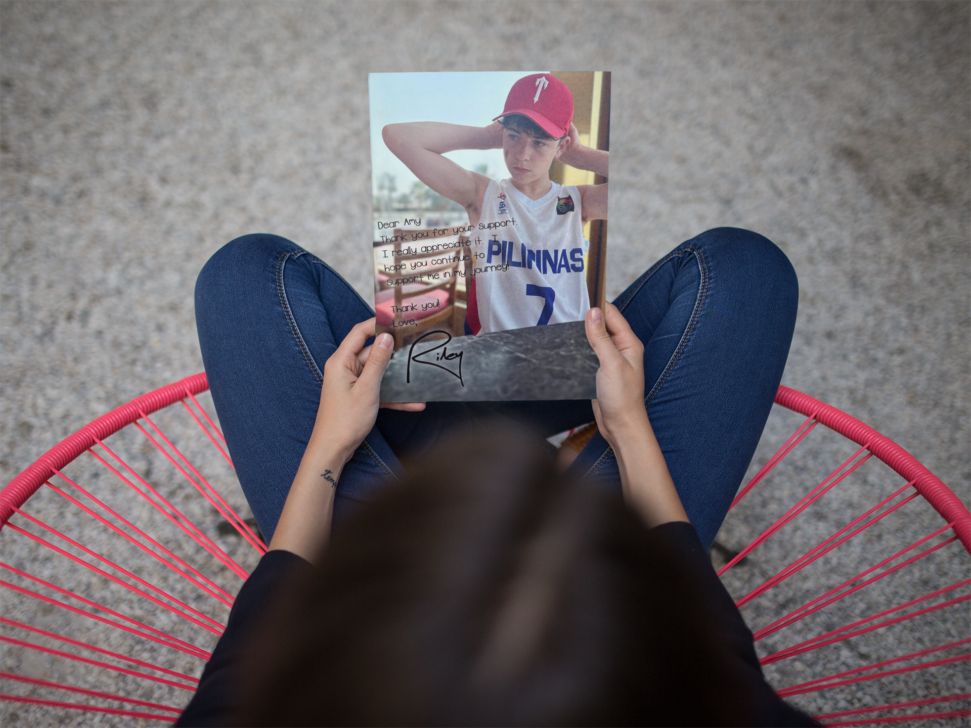 mockup-of-a-girl-holding-a-catalog-while-crossing-her-legs-a14650